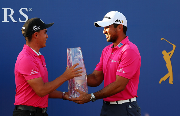 PONTE VEDRA BEACH, FL - MAY 15: Rickie Fowler (L) of the United States presents the trophy to Jason Day of Australia after Day won the final round of THE PLAYERS Championship at the Stadium course at TPC Sawgrass on May 15, 2016 in Ponte Vedra Beach, Florida. (Photo by Mike Ehrmann/Getty Images)